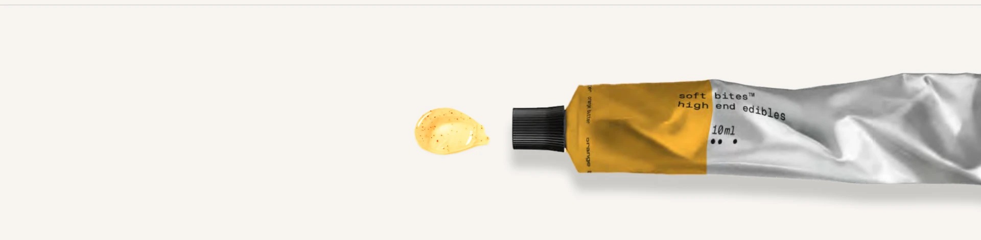 Soft Bites Yuzu Citrus Glow aluminium tube with a smear of paste on a bone surface